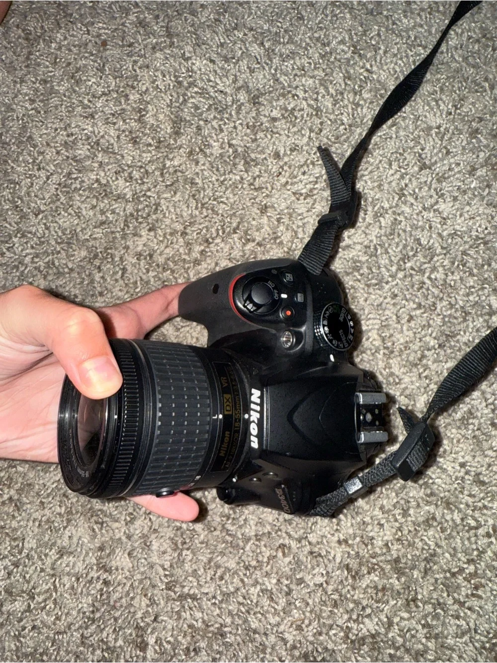 Nikon Black DSLR with Zoom Lens and Branded Neck Strap